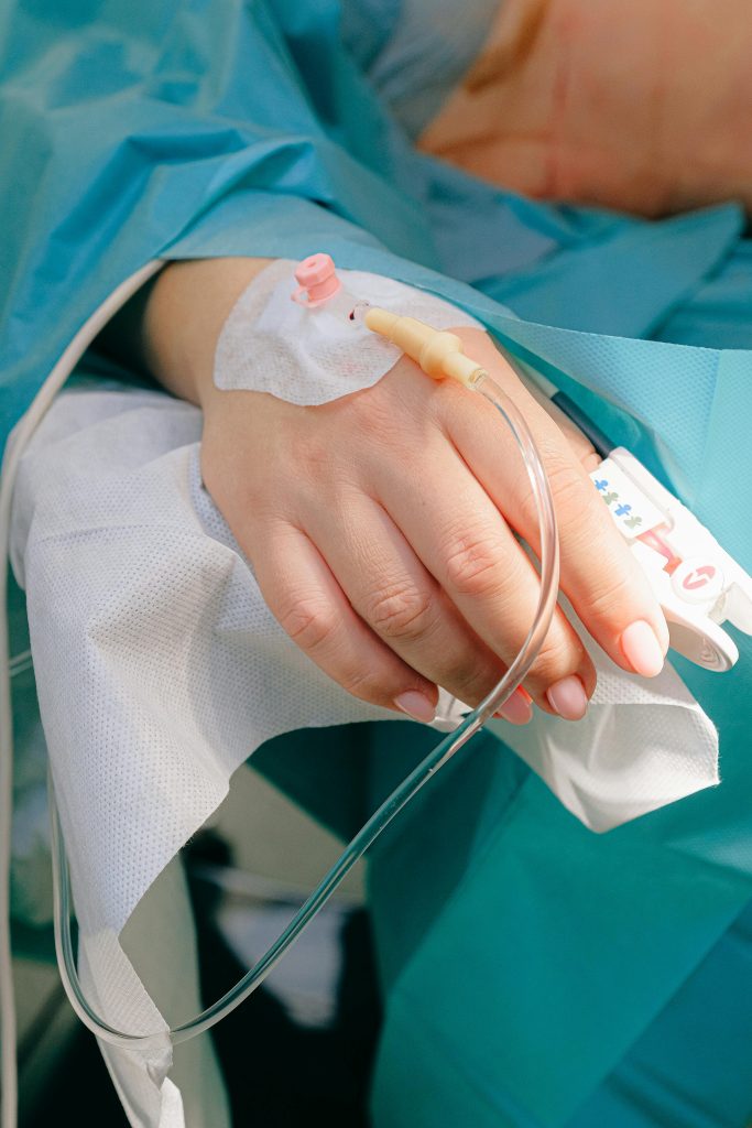 pexels-photo-3845115-3845115 Close-up of a patient's hand receiving intravenous therapy in a hospital setting.